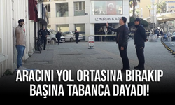 Aracını yol ortasına bırakıp başına tabanca dayadı